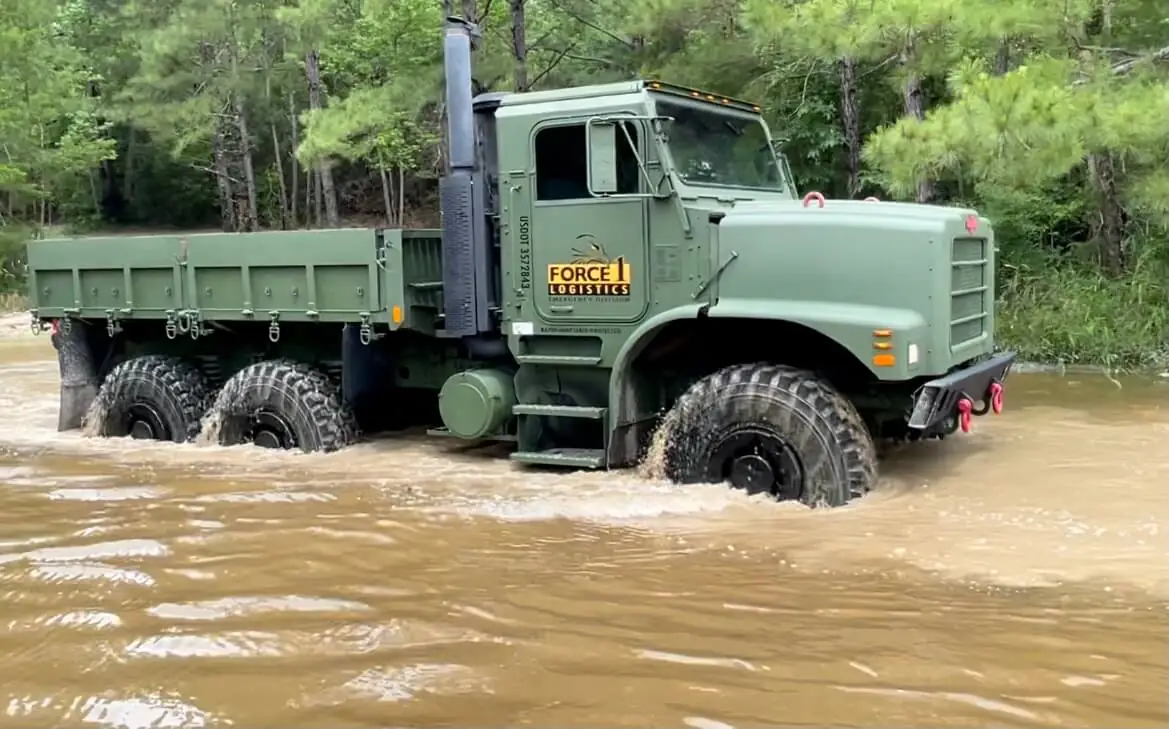 Force 1 Logistics six-wheel truck plowing through flood water